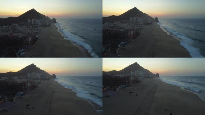 日出时对沿海度假胜地海滩的空中无人机拍摄