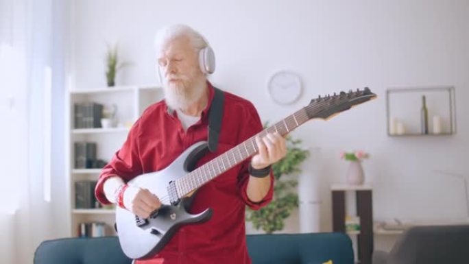 Senior man playing electric guitar, trendy grandpa