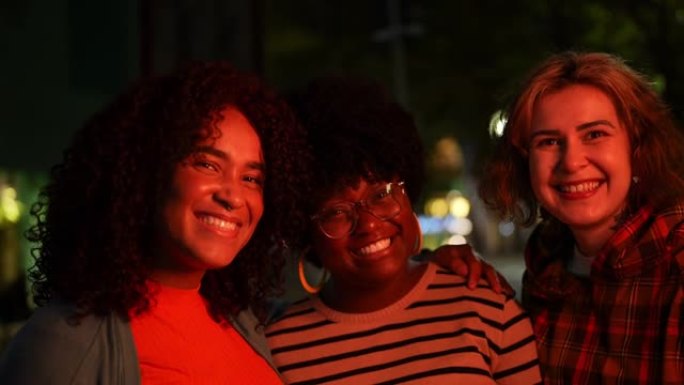 Portrait of happy friends together at night