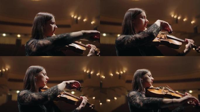 才华横溢的女小提琴家在爱乐音乐厅演奏小提琴，在交响乐团演奏女音乐家