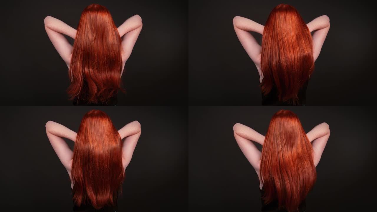 迷人的红发女人翻转她长长的直发。后视图