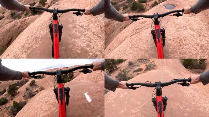 岩石上的山地自行车沙漠路径的第一人称视角