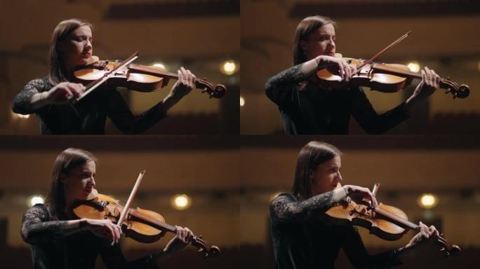 受启发的女小提琴手在交响乐团中演奏旋律，现场的提琴手肖像