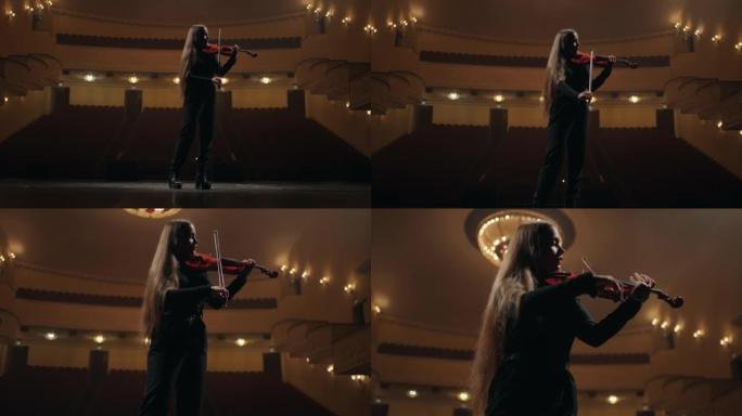女提琴手在爱乐音乐厅拉小提琴，现场有深色剪影