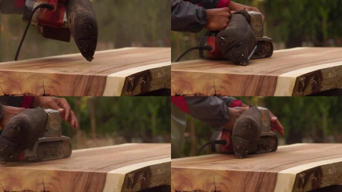 男木匠正在使用电动木工工具在户外工作
