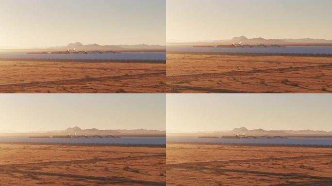黎明日出时贫瘠的沙漠景观和抛物线槽太阳能发电厂