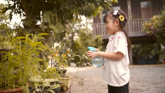 亚洲女孩通过给植物浇水来照顾花盆中的植物