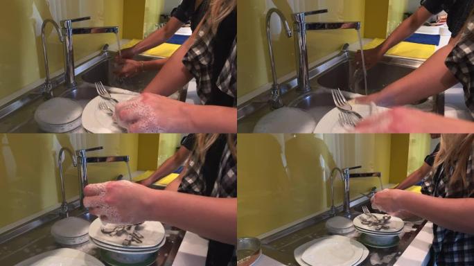 妇女在晚餐后用手洗碗