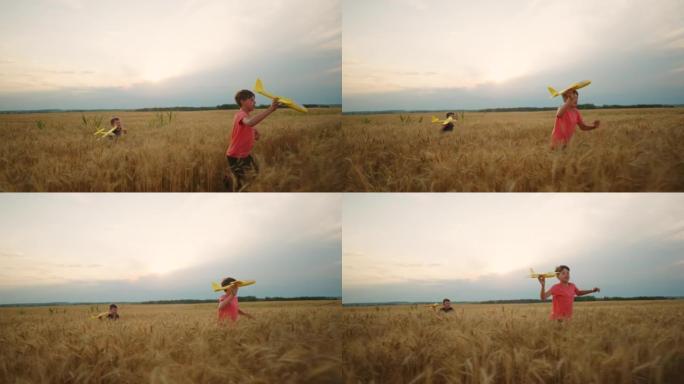 孩子们在金色的麦田里，两个小男孩在成熟的麦穗里玩耍和奔跑