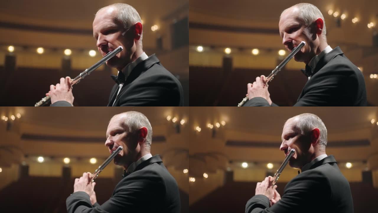 男子在歌剧院或爱乐音乐厅的现场演奏长笛，有才华的长笛演奏家的特写肖像