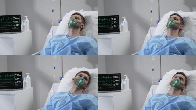 该名男子戴着氧气面罩躺在医院的床上，恢复了意识。连接到呼吸和心率监测器躺在医院的床上，闭着眼睛