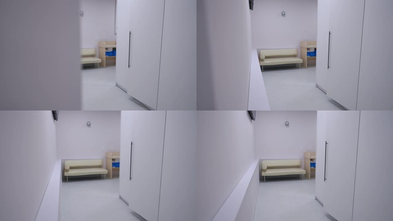 现代医疗诊所室内等候区。实时摄像机从左向右移动，进入室内舒适的沙发进入医院走廊。