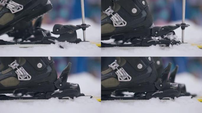 女性滑雪靴穿滑雪板的侧视图特写。在白雪上滑雪设备中无法辨认的女子滑雪者的脚。