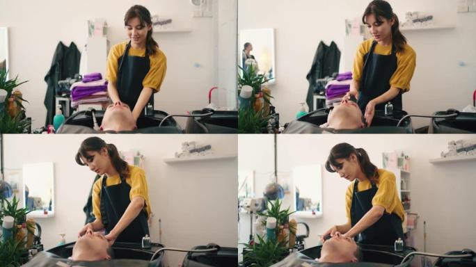 女美发师在理发店用洗发水和护发素给顾客洗头