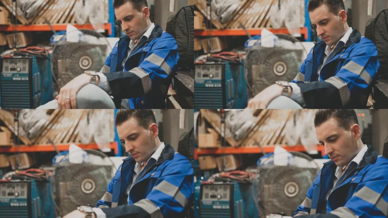 Worker using mobile phone at warehouse.