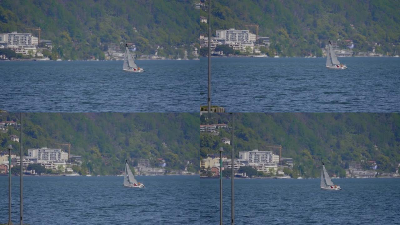 在多风的湖上拍摄帆船的长焦照片