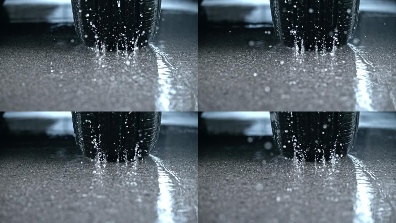 SLO MO TS汽车轮胎在雨水覆盖的沥青上旋转