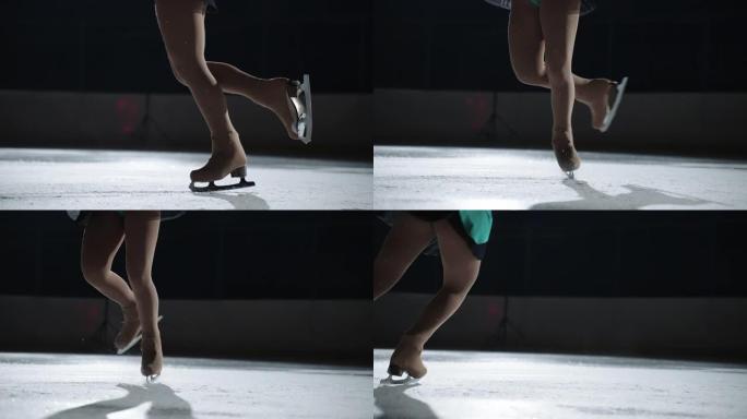 女子单人花样滑冰表演，在黑暗的溜冰场上旋转元素时女运动员的腿特写，比赛和示范表演