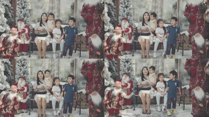 欢快的家庭在圣诞树旁摆姿势拍照