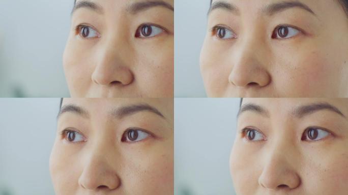 一个深思的亚洲女人的潘眼睛