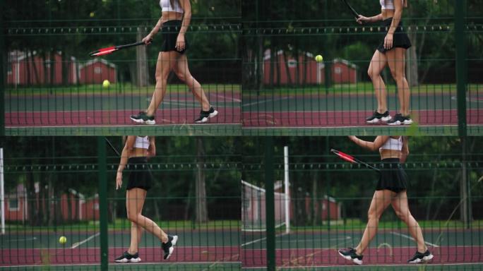 运动的年轻女子正在球场上练习网球，走路和弹跳球，修长的双腿