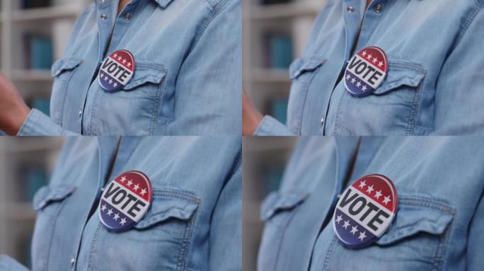 选民衬衫上的特写投票按钮，支持候选人，自由选择