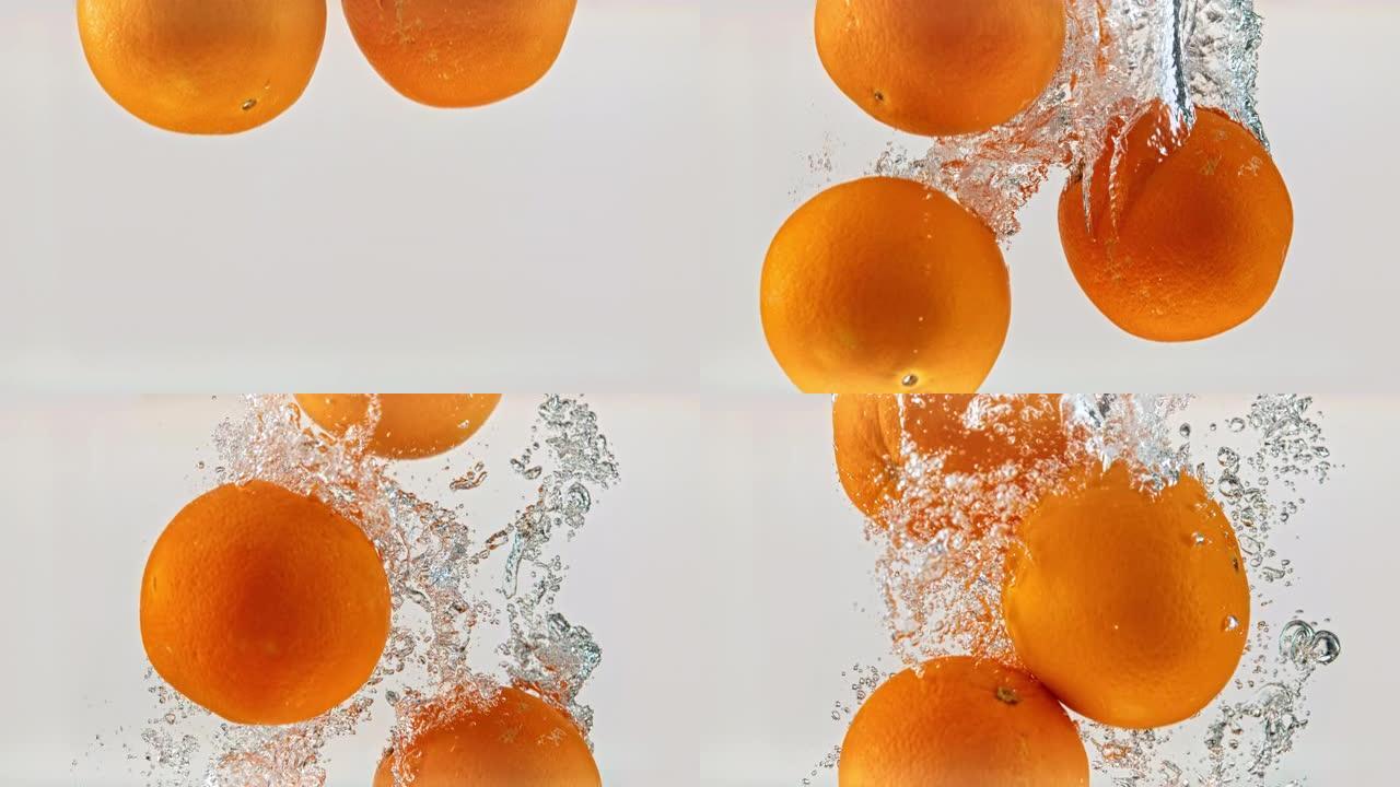 SLO MO LD整个橘子在白色背景下落入水中