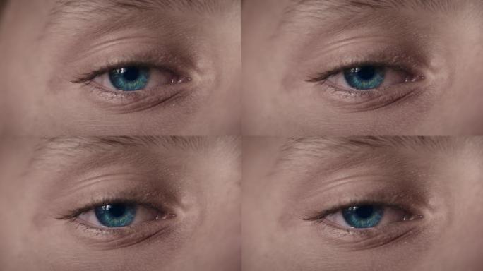 男孩蓝眼睛的极端特写宏观视图。移开目光