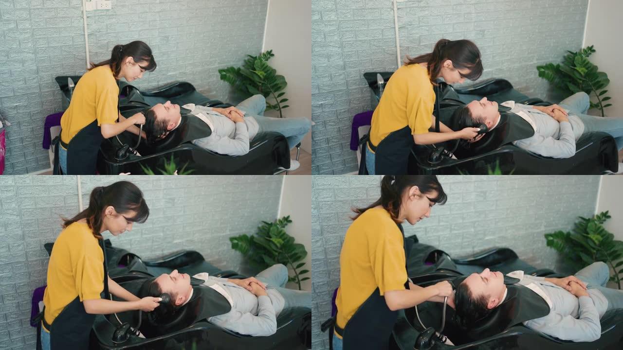 女美发师在理发店用洗发水和护发素给顾客洗头