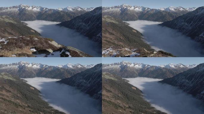 空中无人机射击揭示了被群山环绕的山谷中的低云