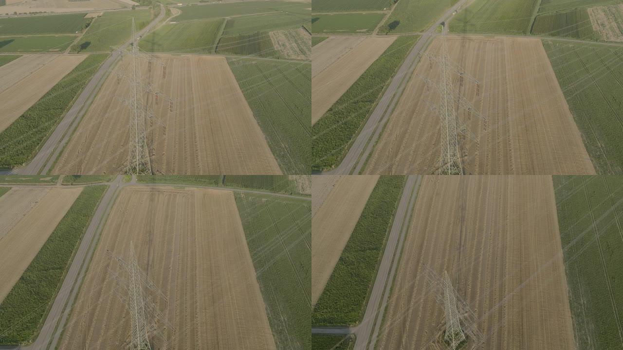 横跨绿色农田的电网电缆