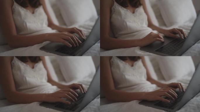 年轻女子在床上使用笔记本电脑