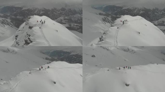 一群滑雪者在山顶上的空中无人机拍摄