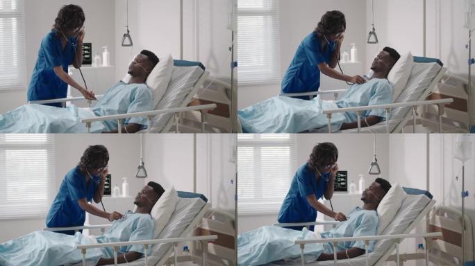 一名女医生检查并与躺在医院病床上的病人交谈