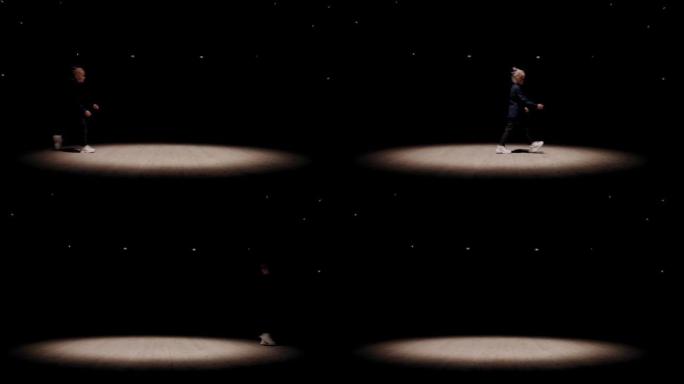 小女孩像机器人一样走在剧院现场，当代舞蹈表演，循环拍摄