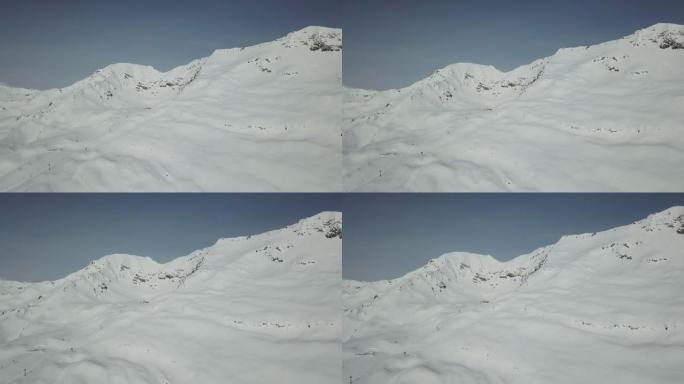 空中无人机拍摄积雪覆盖的山脉和滑雪场