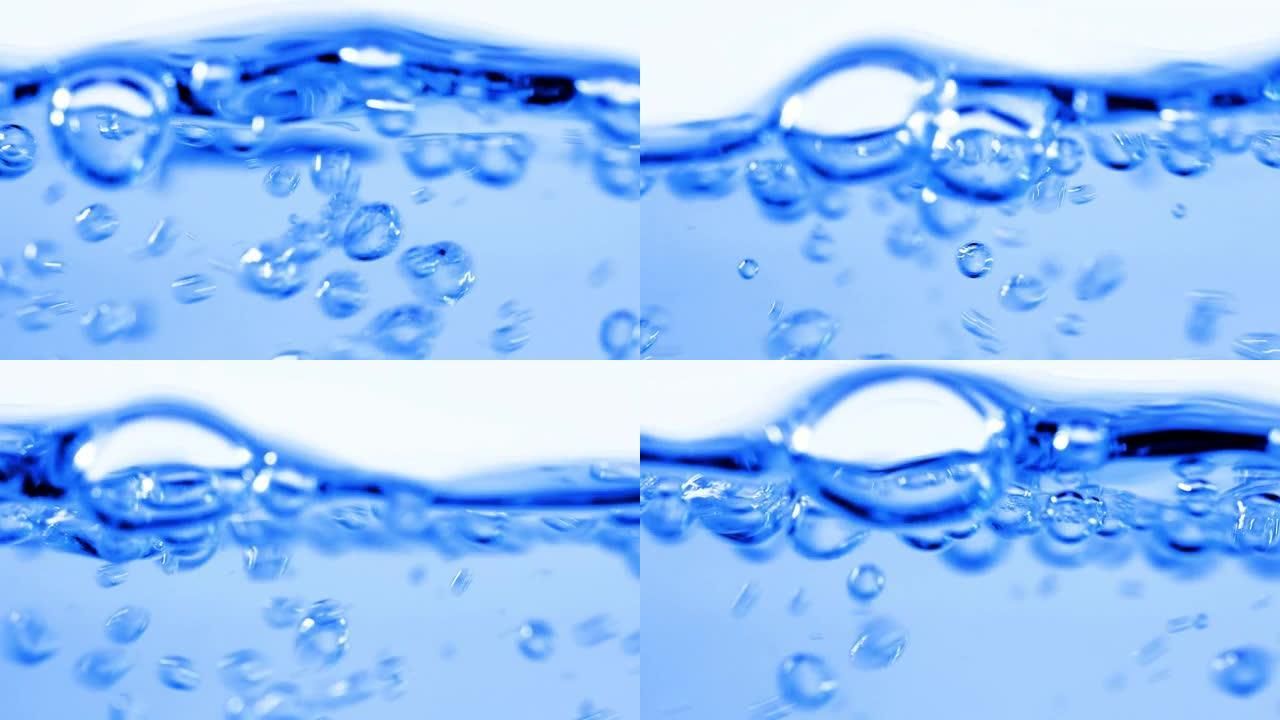 水中的许多气泡关闭，抽象的水波与慢动作中的气泡