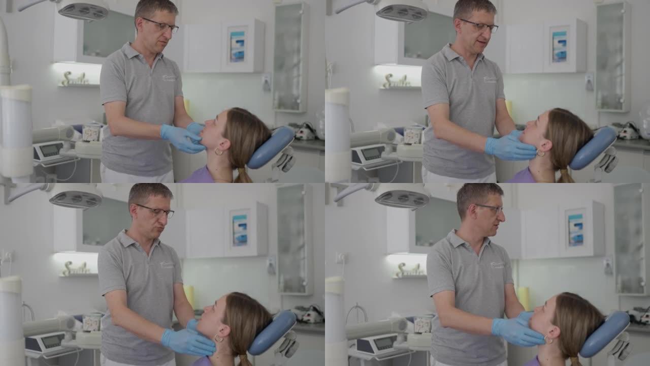 男性牙医触诊女性患者颞下颌关节