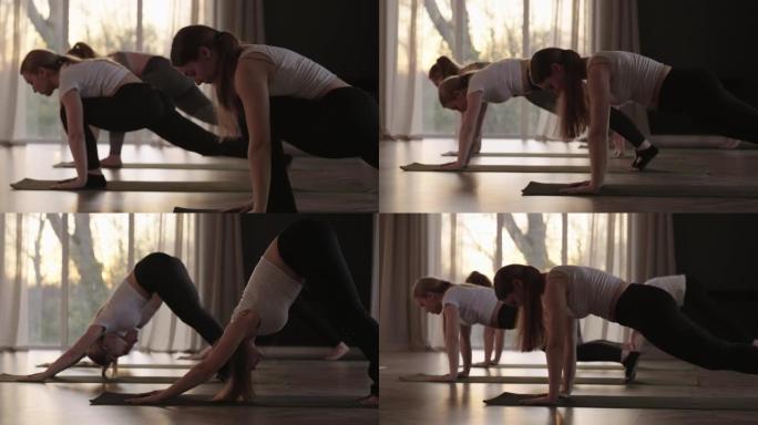 年轻的高加索运动人士与教练一起练习瑜伽课。在健身工作室锻炼健康生活方式的高加索妇女群体。体育活动，体