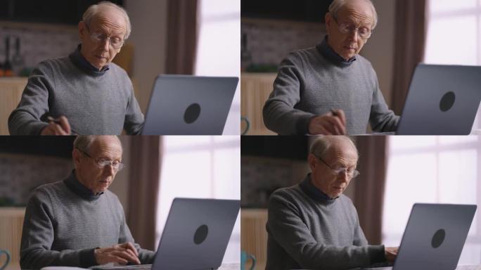单身老人正在计算自己的费用和计划预算，在厨房工作，使用笔记本电脑和计算器