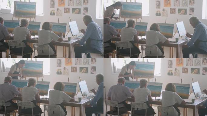 一位年轻的女美术老师为一群退休人员展示了用画布上的丙烯酸颜料绘画的技术。高级男女团体