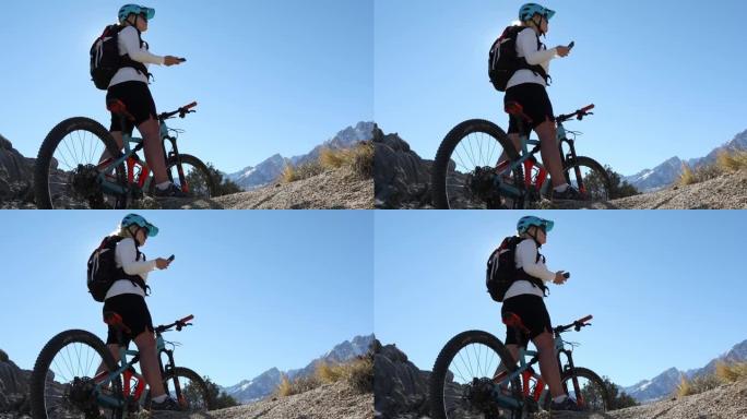 女性山地自行车手穿越岩石脊顶