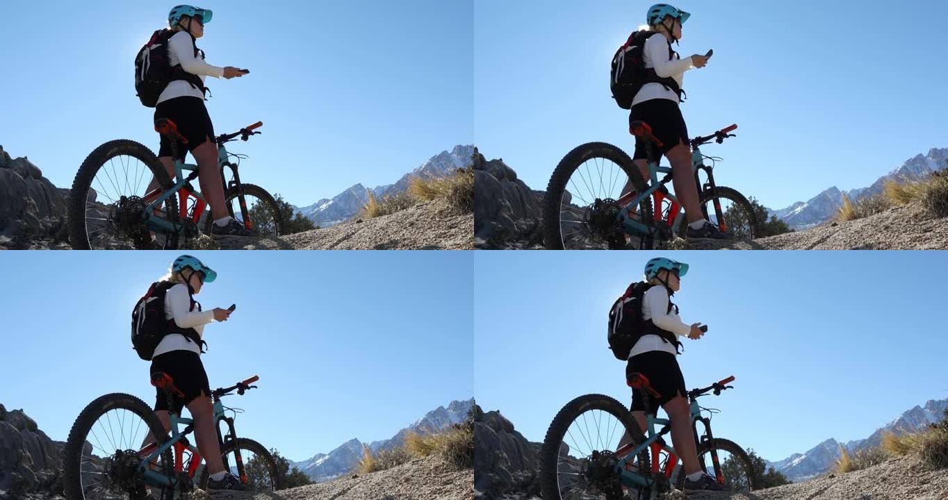 女性山地自行车手穿越岩石脊顶