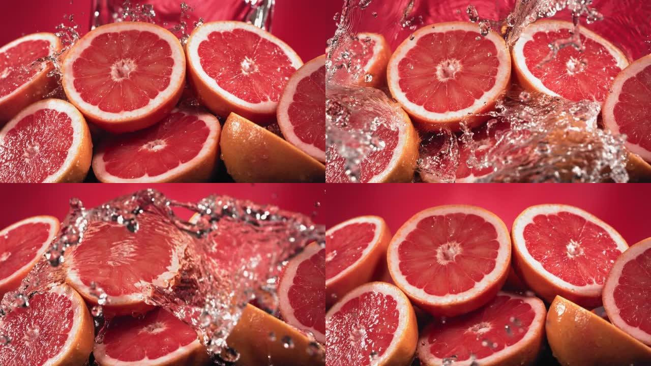 葡萄柚水通过葡萄柚切片飞溅的慢动作镜头