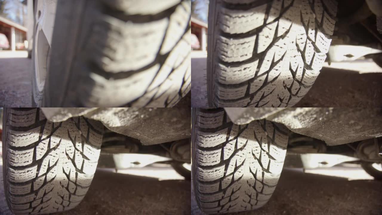跟踪显示了胎面相当多的汽车轮胎的照片，阳光明媚
