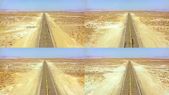 航拍:在美国内华达州的沙漠中，沿着一条道路前行