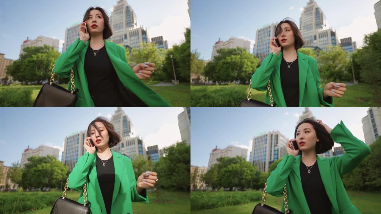 自信而成功的韩国女商人独自行走，用手机聊天，肖像