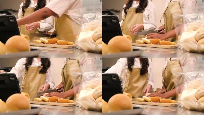 两名创业厨师现场直播秀，演示在厨房切片面包。