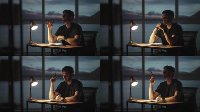 一个体贴的人坐在桌子旁，背景是海洋和大海的窗户。一个不安分的人坐在桌子旁，拿着台灯