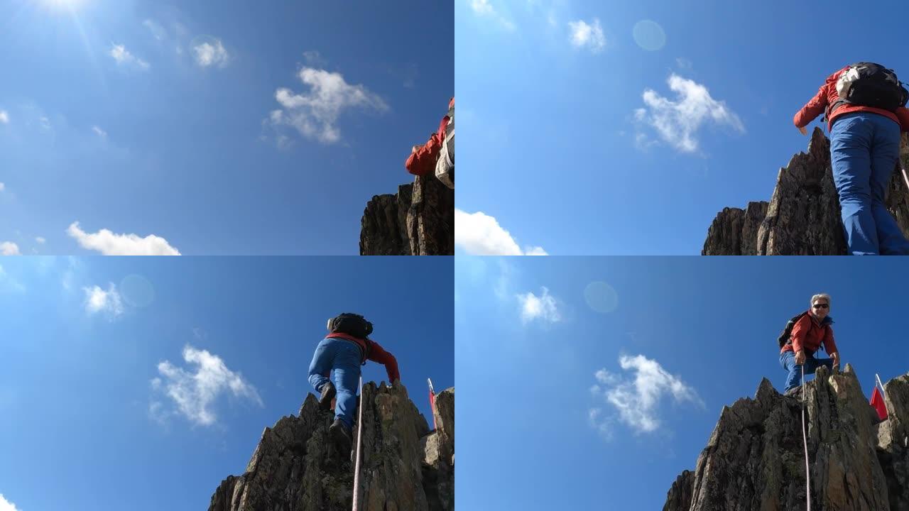 男性登山运动员攀登陡峭的岩岭